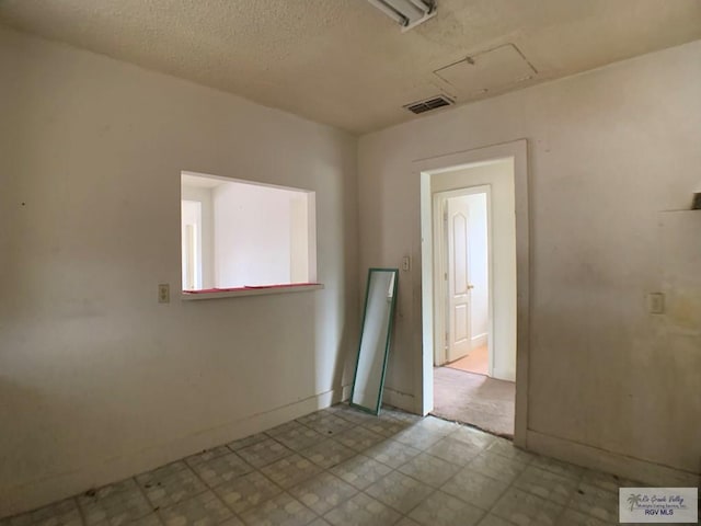 empty room featuring tile patterned floors and visible vents