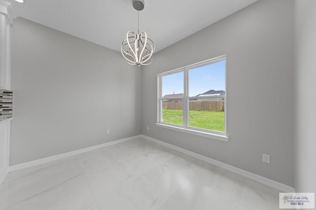 32722 Jorge St, Los Fresnos, TX 78566 - empty room featuring light marble finish flooring and a chandelier