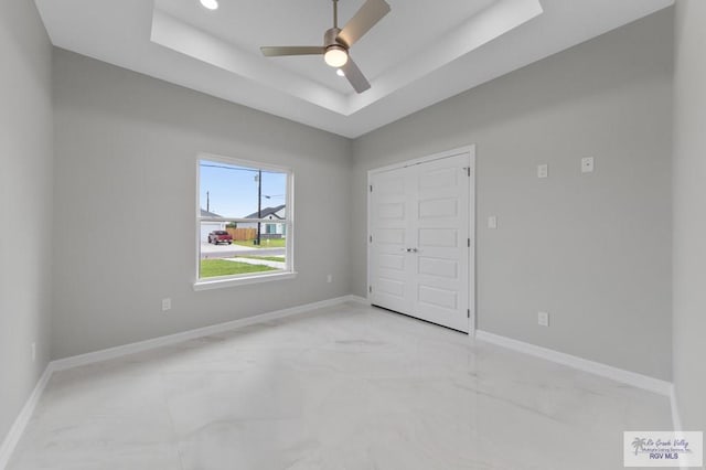 32722 Jorge St, Los Fresnos, TX 78566 - unfurnished bedroom featuring a raised ceiling and ceiling fan