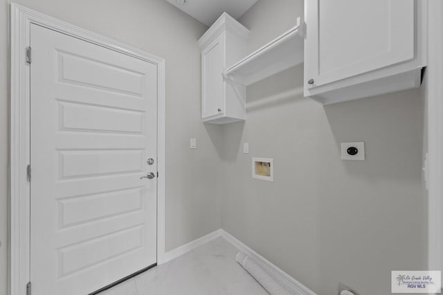 32722 Jorge St, Los Fresnos, TX 78566 - washroom with electric dryer hookup, hookup for a washing machine, light marble finish floors, and cabinet space