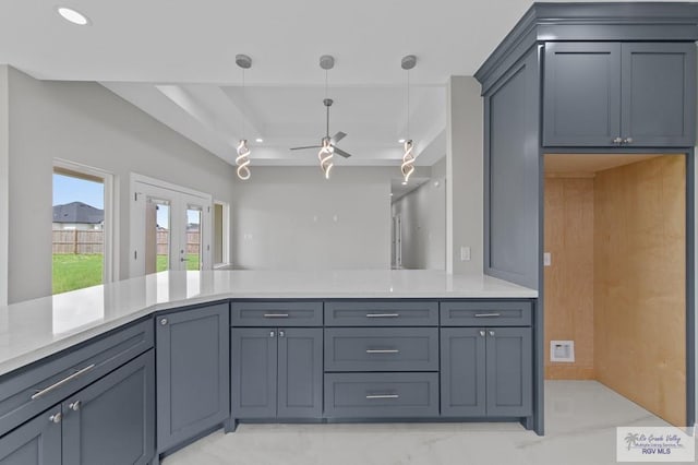 32722 Jorge St, Los Fresnos, TX 78566 - kitchen with a ceiling fan, hanging light fixtures, a raised ceiling, french doors, and a peninsula