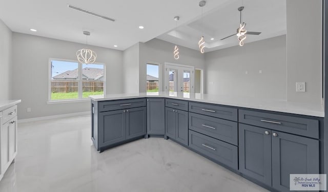 32722 Jorge St, Los Fresnos, TX 78566 - kitchen with light countertops, recessed lighting, a ceiling fan, decorative light fixtures, and a tray ceiling