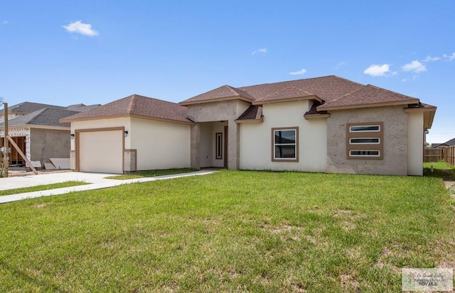 32722 Jorge St, Los Fresnos, TX 78566 - view of front facade with an attached garage, driveway, stucco siding, and roof with shingles