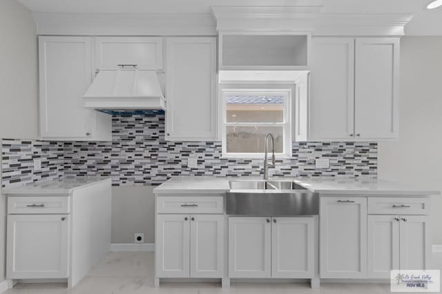 32722 Jorge St, Los Fresnos, TX 78566 - kitchen with light countertops, tasteful backsplash, and white cabinets