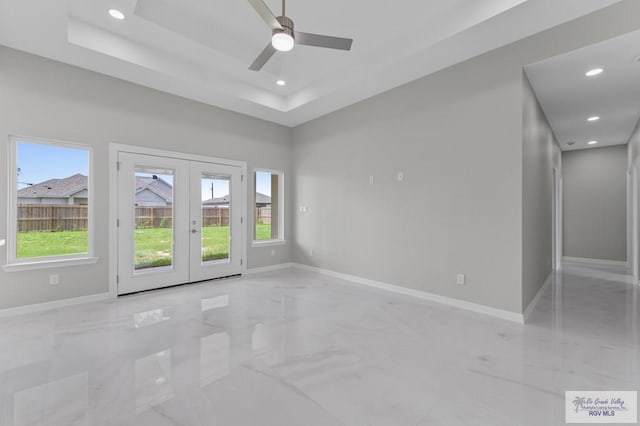 32722 Jorge St, Los Fresnos, TX 78566 - empty room featuring french doors, light marble finish floors, ceiling fan, recessed lighting, and a tray ceiling