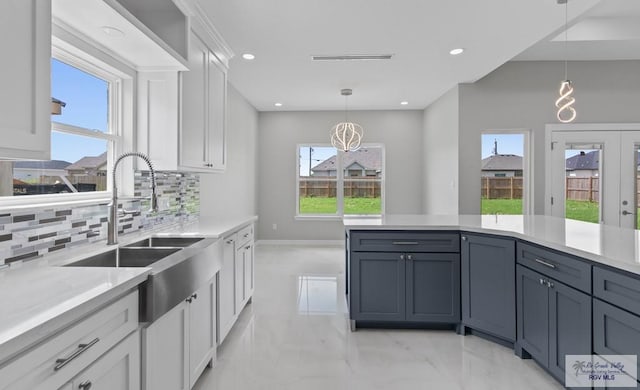 32722 Jorge St, Los Fresnos, TX 78566 - kitchen featuring decorative backsplash, white cabinetry, healthy amount of natural light, and recessed lighting