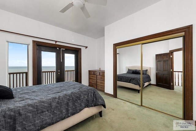 1810 N Shore Dr, Port Isabel, TX 78578 - bedroom featuring light colored carpet, access to outside, french doors, a water view, and a closet