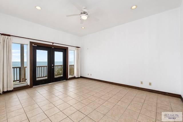 1810 N Shore Dr, Port Isabel, TX 78578 - unfurnished room with french doors, plenty of natural light, a water view, recessed lighting, and ceiling fan