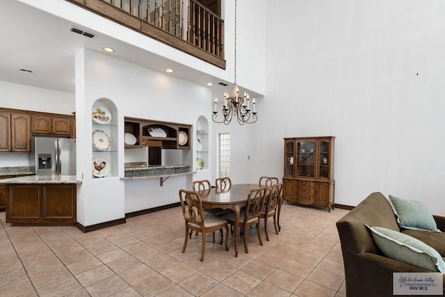 1810 N Shore Dr, Port Isabel, TX 78578 - dining room with a towering ceiling, a chandelier, and light tile patterned floors