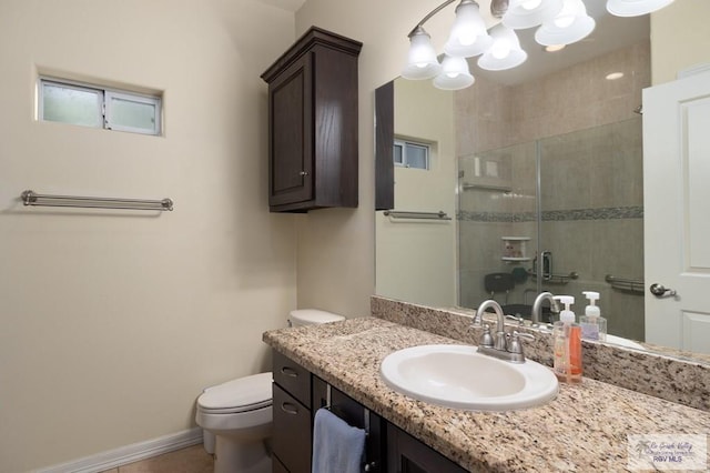 bathroom with toilet, a shower with shower door, and vanity