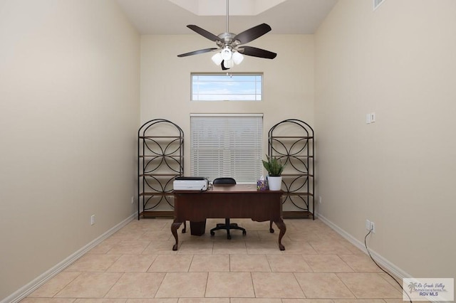 tiled home office featuring ceiling fan