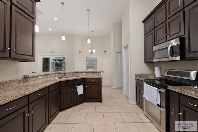 kitchen featuring decorative light fixtures, stainless steel appliances, sink, an inviting chandelier, and dark brown cabinetry