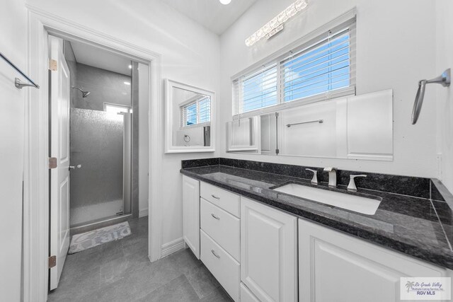 bathroom with vanity and a shower with door