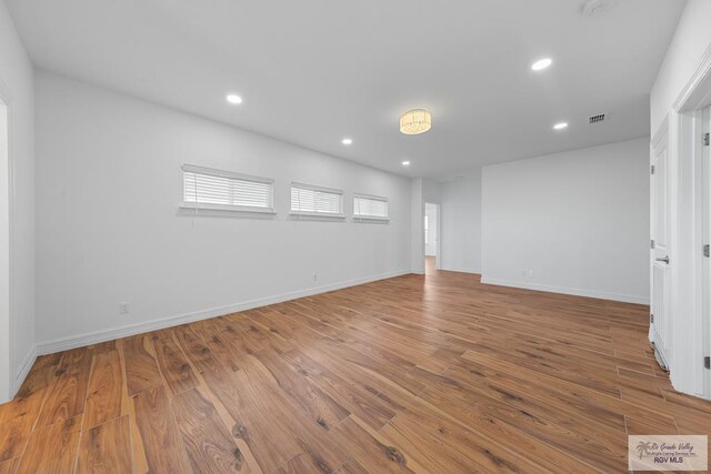 unfurnished room with hardwood / wood-style floors