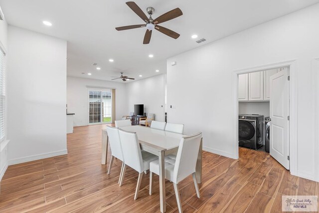 dining area featuring ceiling fan, washer and clothes dryer, and light hardwood / wood-style flooring