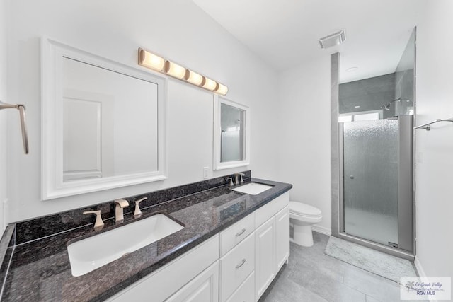 bathroom with tile patterned flooring, vanity, toilet, and an enclosed shower