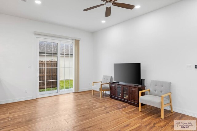 living area featuring ceiling fan and light wood-type flooring