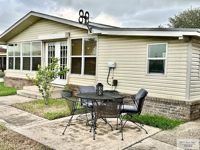 rear view of property with french doors and a patio