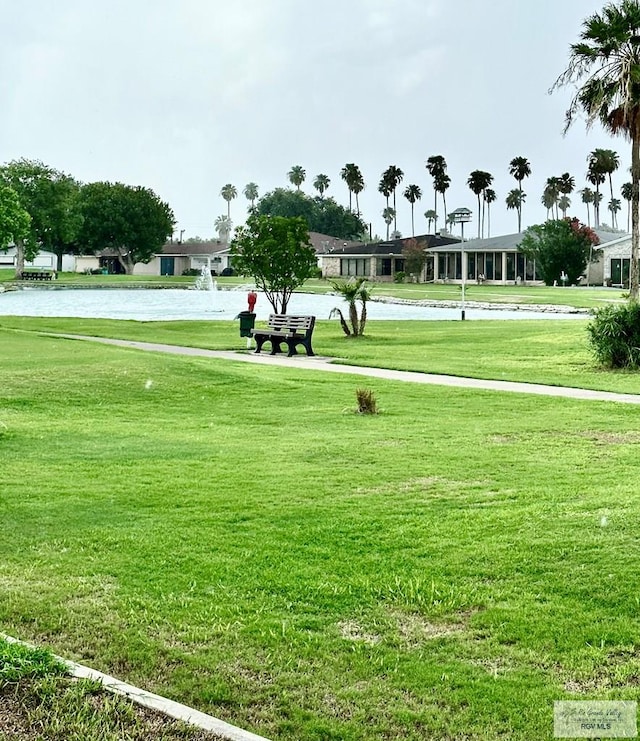 view of home's community featuring a water view and a lawn