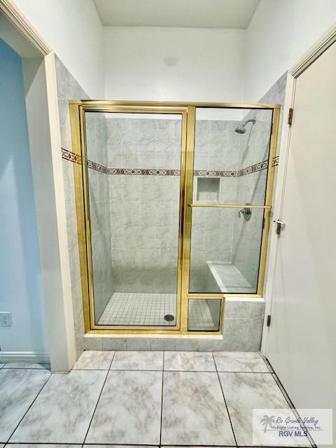 bathroom featuring tile patterned floors and walk in shower