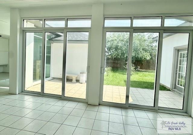 doorway with light tile patterned flooring