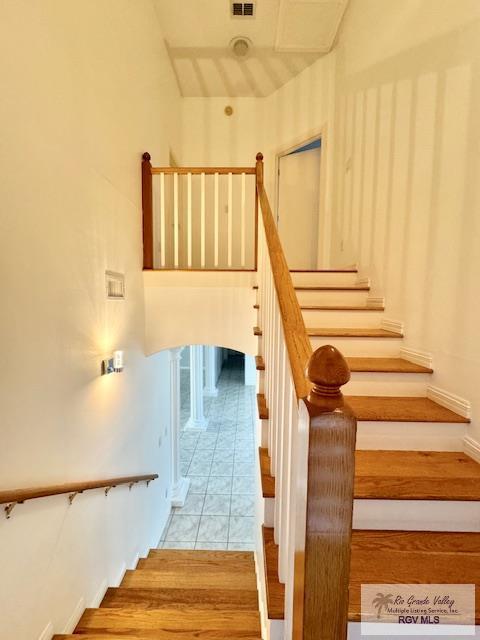 stairs featuring hardwood / wood-style floors