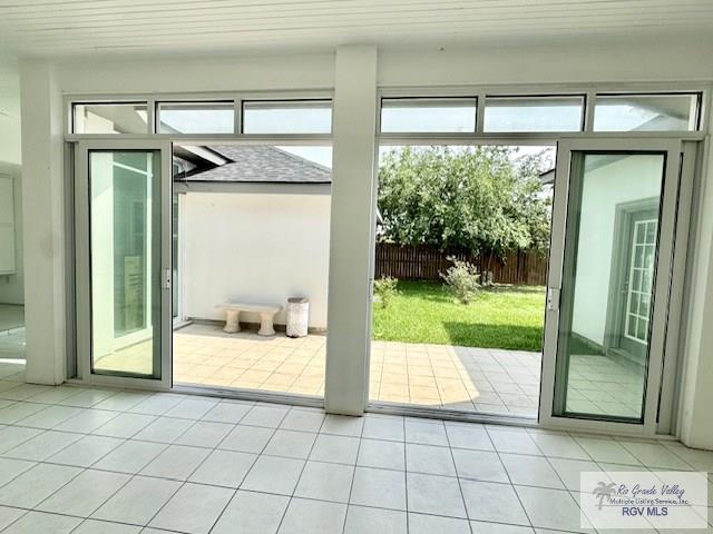 doorway featuring light tile patterned flooring