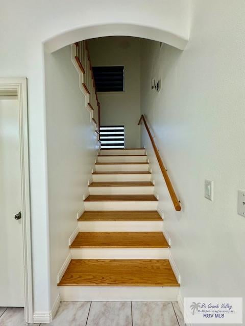 stairs featuring tile patterned flooring