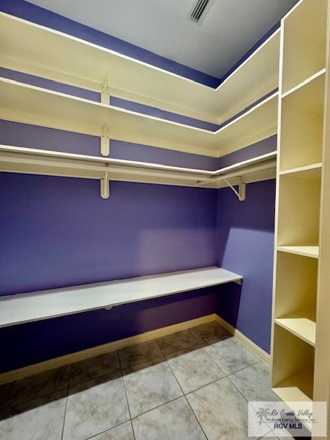 spacious closet with tile patterned flooring