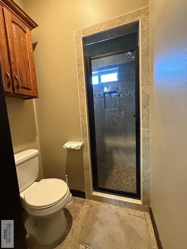 2909 Mi Cielo Dr, Weslaco, TX 78599 - full bathroom with toilet, a stall shower, and baseboards