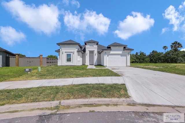 4698 Kalinga Ln, Brownsville, TX 78521 - prairie-style house with a garage, concrete driveway, and stucco siding
