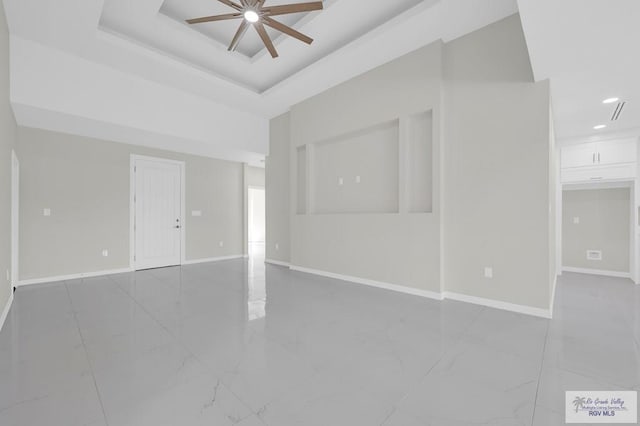 4698 Kalinga Ln, Brownsville, TX 78521 - empty room featuring ceiling fan, baseboards, recessed lighting, marble finish floors, and a tray ceiling