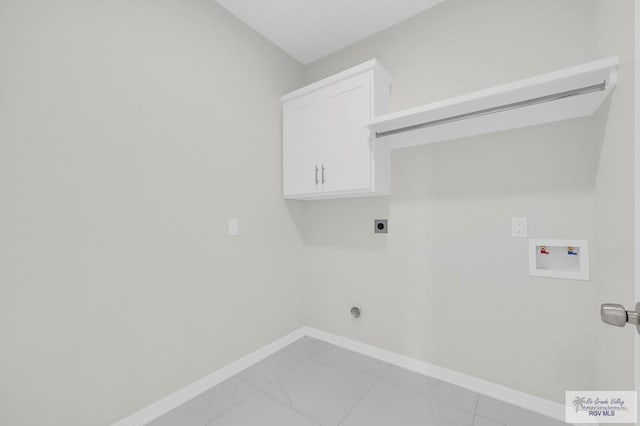 4698 Kalinga Ln, Brownsville, TX 78521 - washroom with electric dryer hookup, hookup for a washing machine, baseboards, and cabinet space