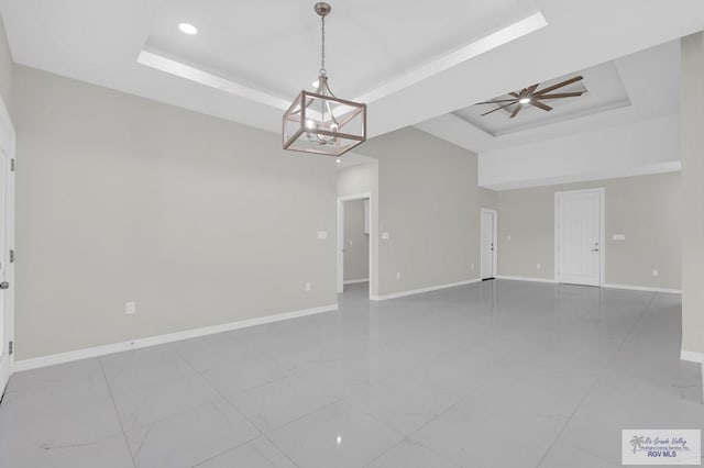 4698 Kalinga Ln, Brownsville, TX 78521 - unfurnished room with a raised ceiling, baseboards, ceiling fan, a chandelier, and recessed lighting