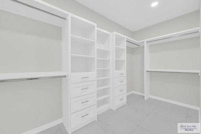 4698 Kalinga Ln, Brownsville, TX 78521 - walk in closet featuring light marble finish flooring