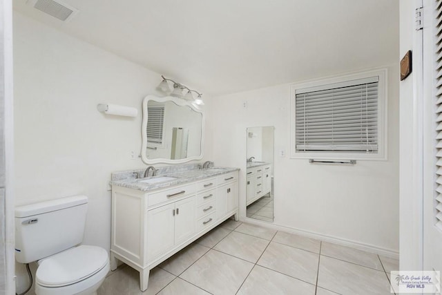 bathroom with tile patterned floors, vanity, and toilet