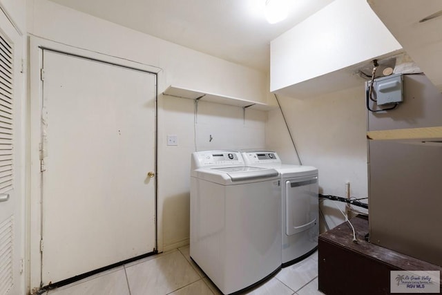 laundry area featuring separate washer and dryer and light tile patterned floors