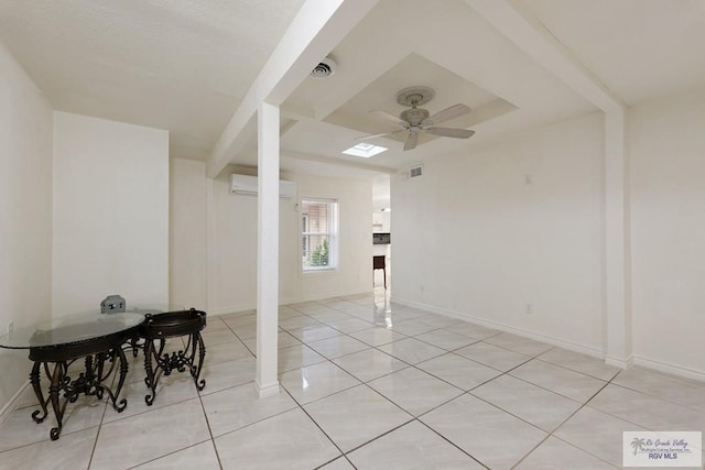 unfurnished room with a wall mounted air conditioner, ceiling fan, and light tile patterned floors