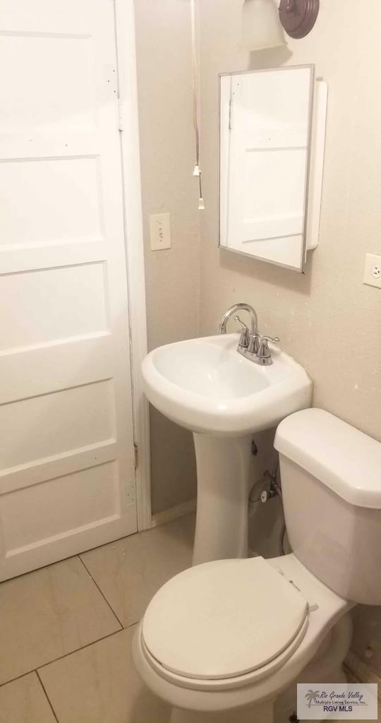 bathroom with tile patterned floors and toilet