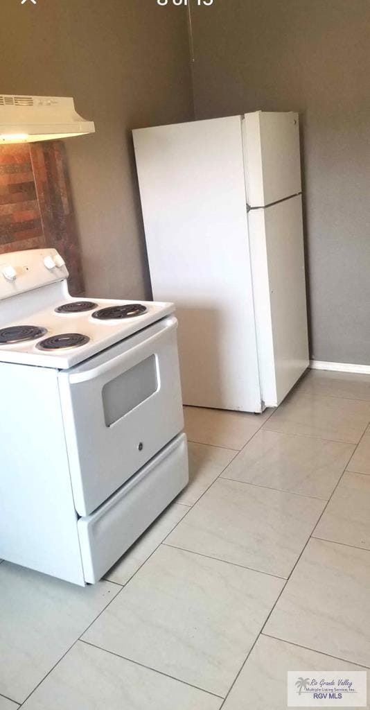 kitchen featuring white appliances and light tile patterned floors