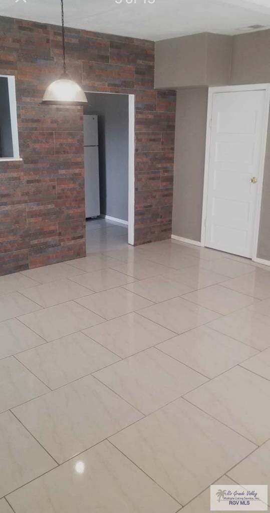 unfurnished room with light tile patterned floors