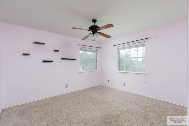 unfurnished room with ceiling fan and light carpet