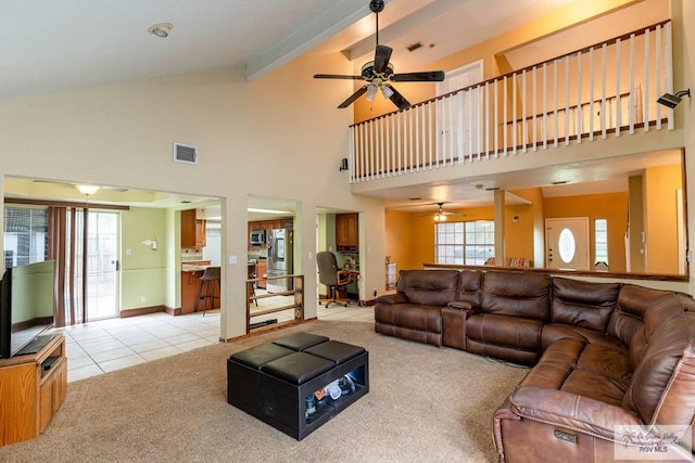 carpeted living room featuring beamed ceiling, ceiling fan, and high vaulted ceiling