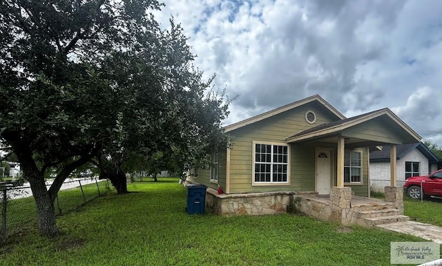 bungalow-style home with a front yard