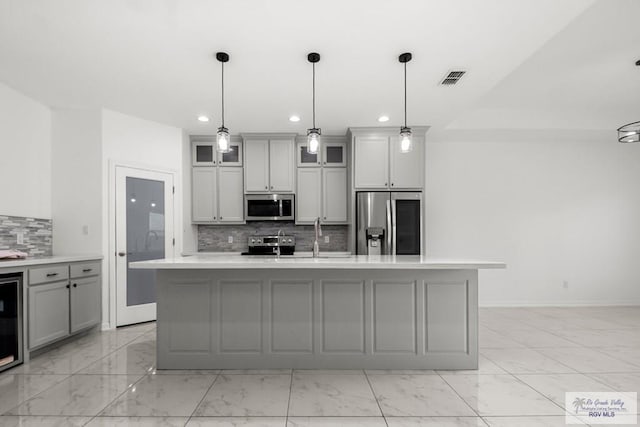 kitchen featuring gray cabinetry, stainless steel appliances, recessed lighting, and marble finish floor