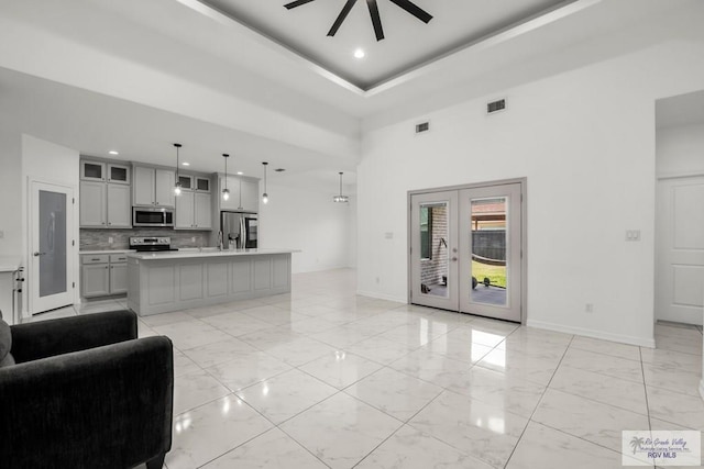 living room featuring visible vents, recessed lighting, marble finish floor, and french doors