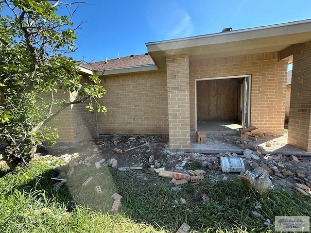 exterior space featuring brick siding