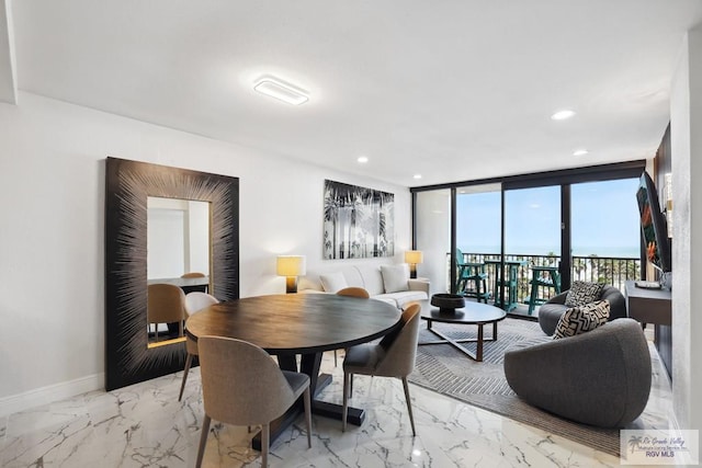 dining room with marble finish floor, baseboards, a wall of windows, and recessed lighting