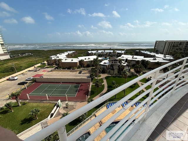 exterior space with tennis court and a water view