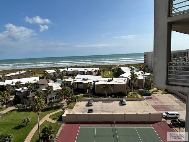 drone / aerial view featuring a beach view and a water view